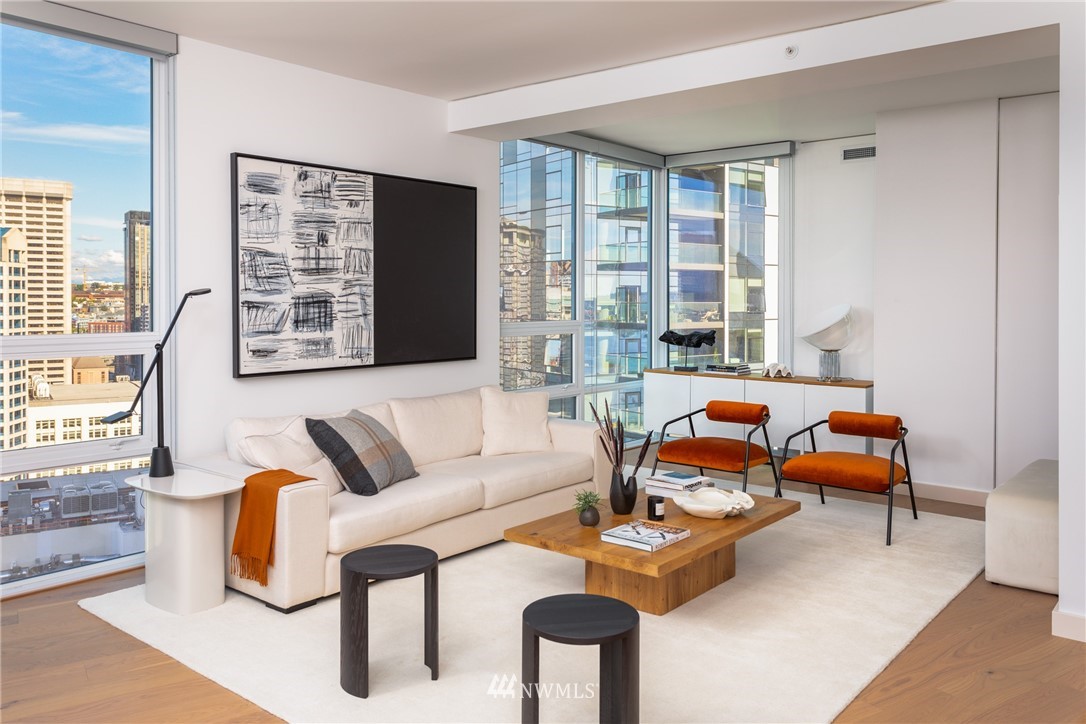 121 Stewart Street, Unit 2201 Seattle, WA 98101 - Photo 7 of 23 a living room with furniture and a large window