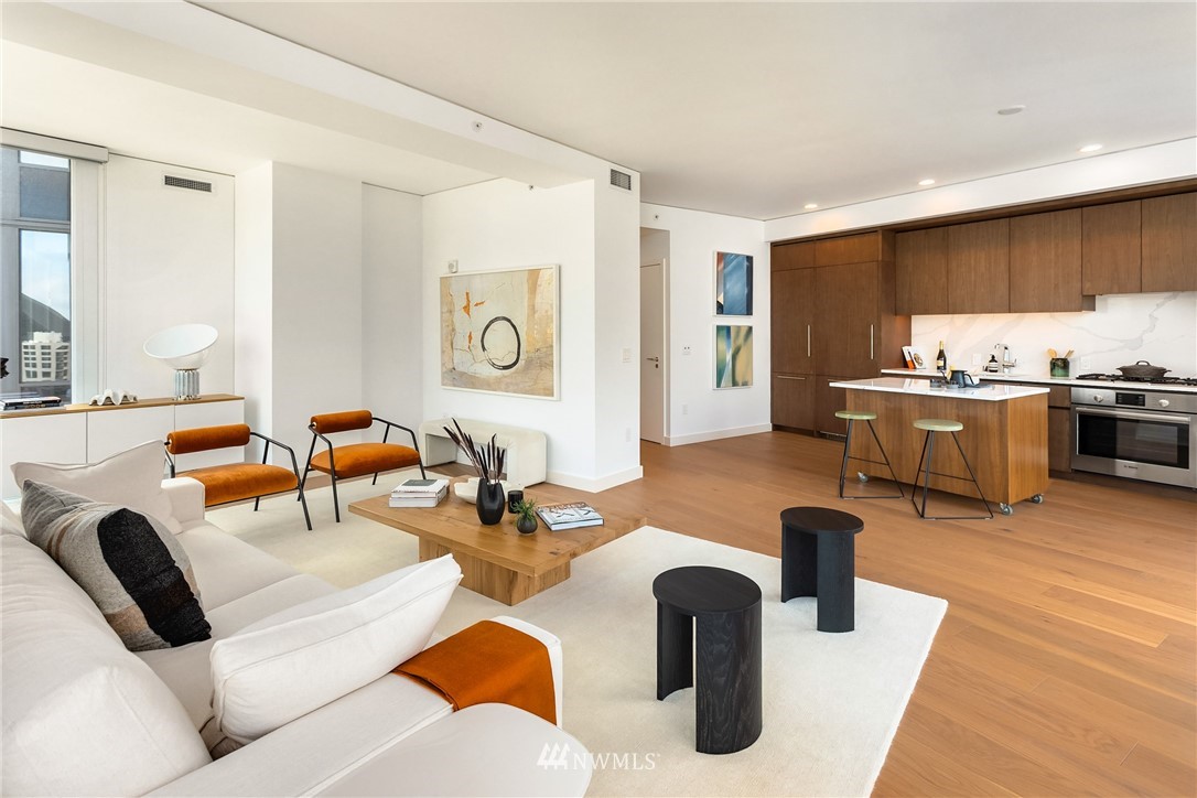 121 Stewart Street, Unit 2201 Seattle, WA 98101 - Photo 10 of 23 a living room with furniture kitchen view and a large window