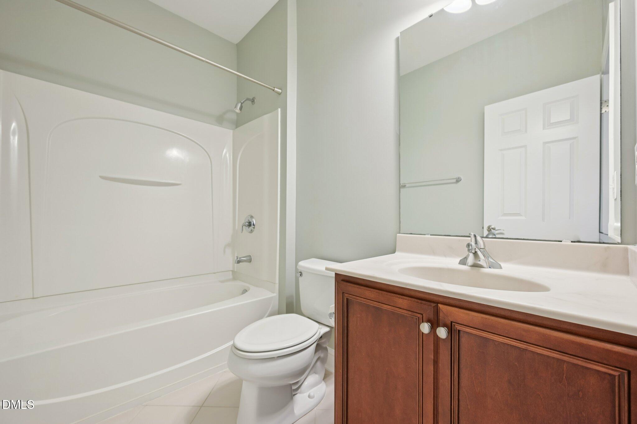 10510 Sablewood Drive, Unit 113 Raleigh, NC 27617 - Photo 29 of 38 a bathroom with a sink a toilet and shower
