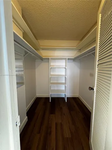 a view of an empty room and wooden floor