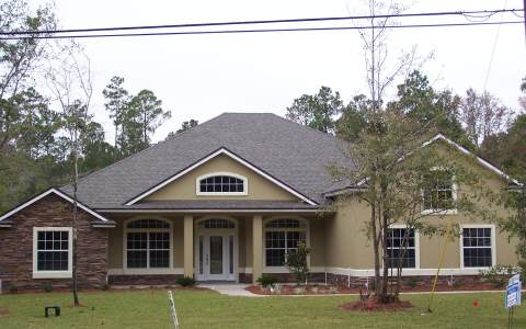 a front view of a house with a yard
