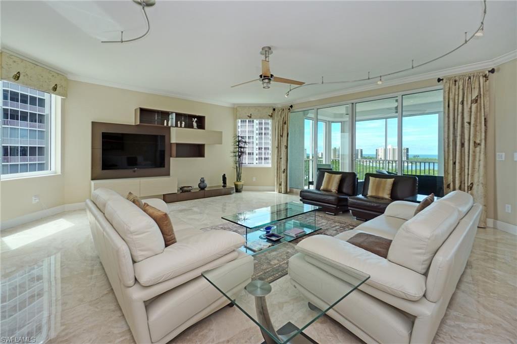 265 Indies Way, Unit 701 Naples, FL 34110 - Photo 2 of 36 a living room with furniture and a flat screen tv