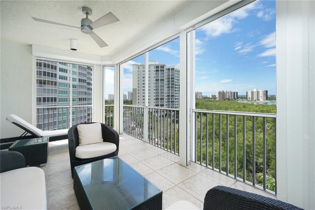 265 Indies Way, Unit 701 Naples, FL 34110 - Photo 24 of 36 a living room with furniture and a floor to ceiling window
