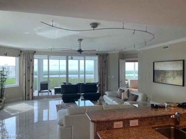 265 Indies Way, Unit 701 Naples, FL 34110 - Photo 6 of 36 a living room with furniture and large windows