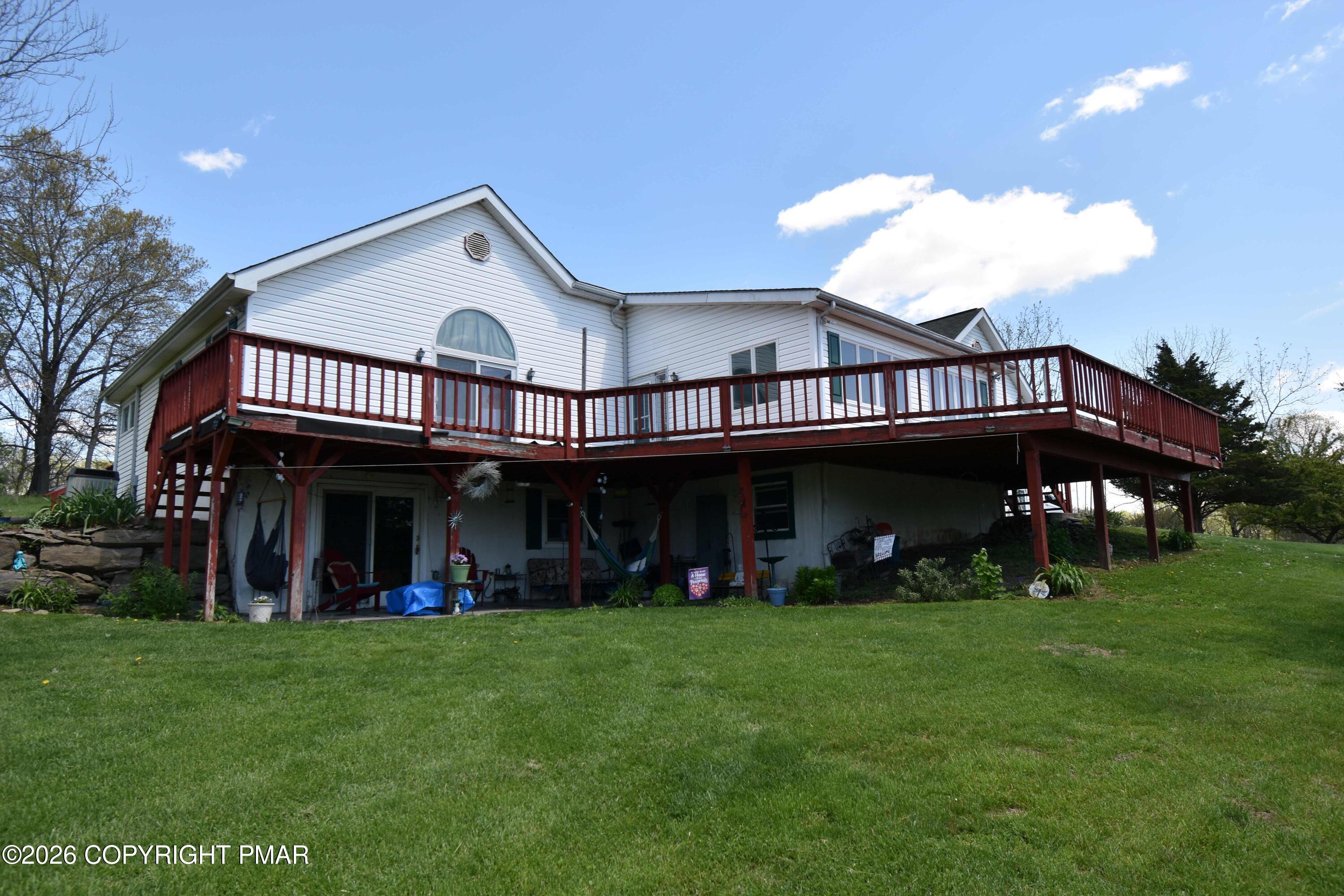 160 Quiet Valley Road Mount Bethel, PA 18343 - Photo 10 of 44 a view of a house with a yard and a garden