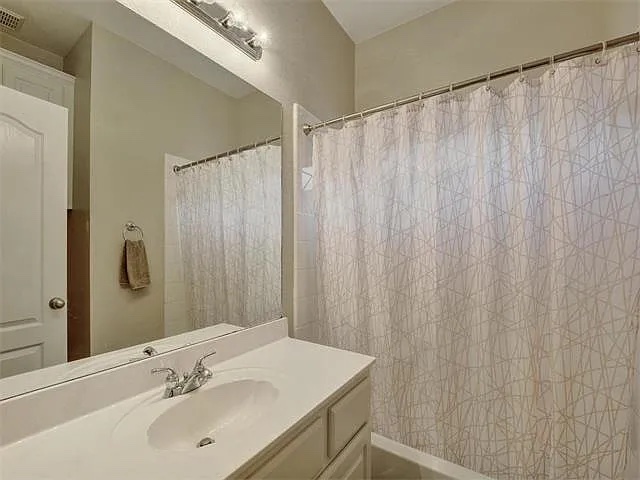 1832 Nelson Ranch Loop Cedar Park, TX 78613 - Photo 12 of 15 A well-appointed bathroom features a single vanity, ample mirror, and an inviting shower.