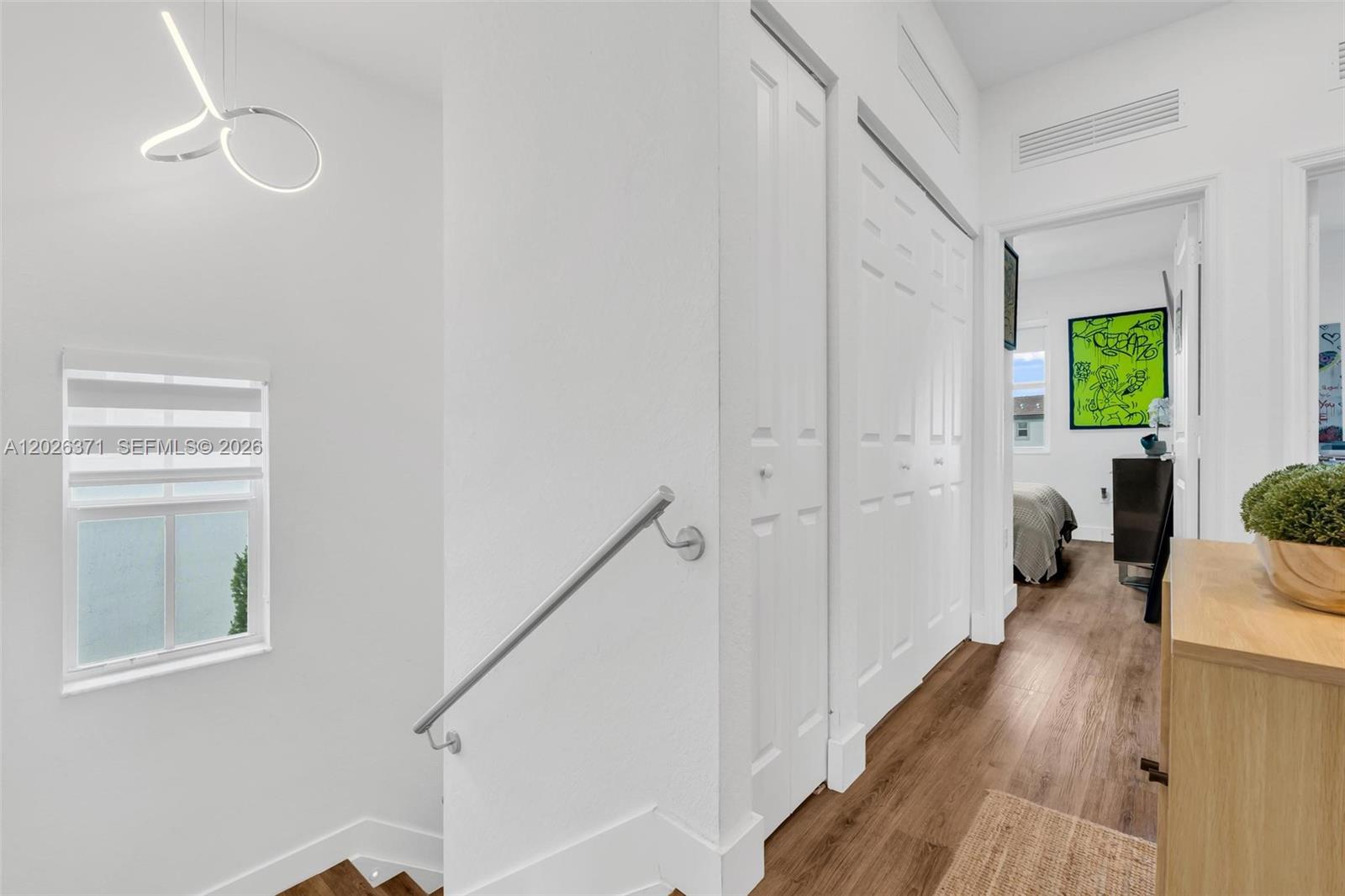 2273 Northwest 131st Circle Miami, FL 33167 - Photo 25 of 46 a view of a hallway with wooden floor and staircase