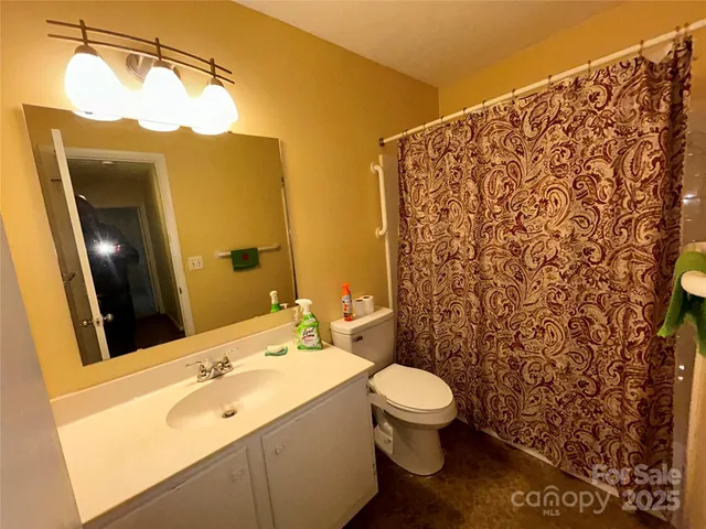 a bed room with a bed and a chair