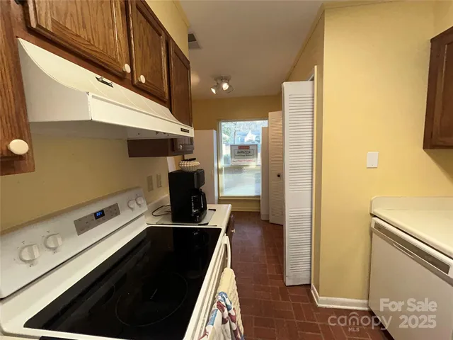 a utility room with cabinets washer and dryer
