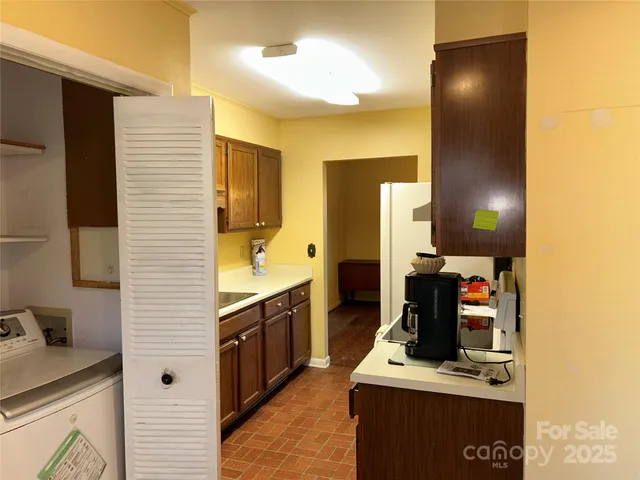a view of empty room with fireplace and wooden floor