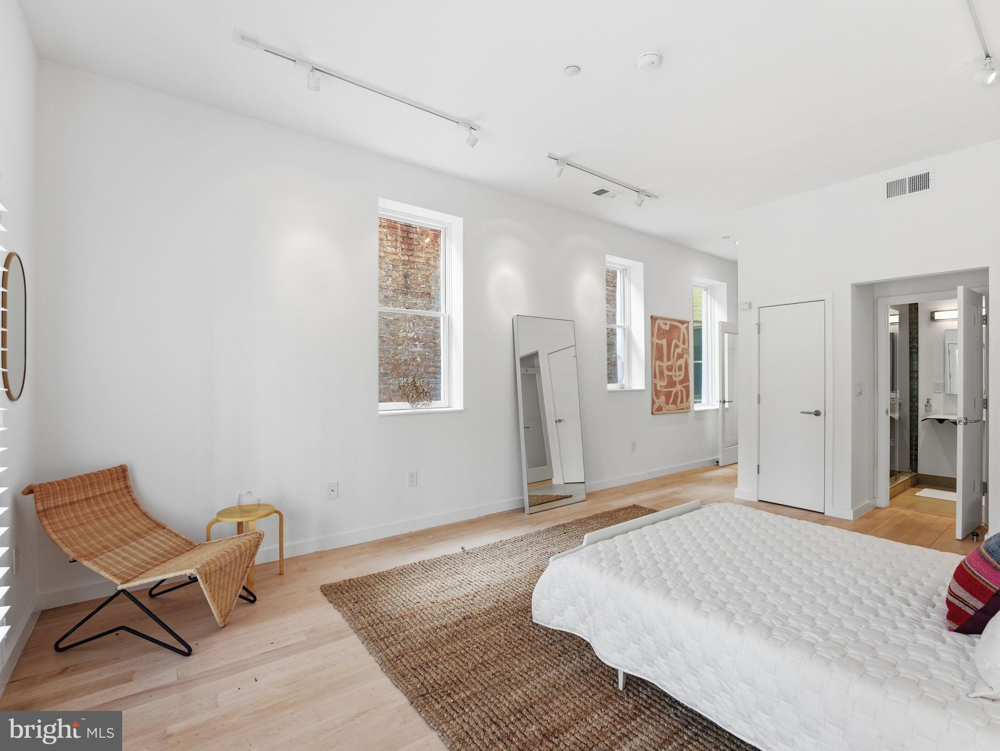 1845 Calvert Street Northwest Washington, DC 20009 - Photo 42 of 48 a bedroom with a bed and wooden floor