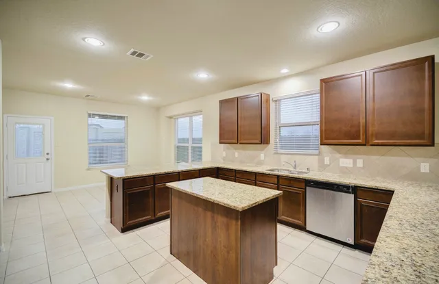 a kitchen with stainless steel appliances granite countertop a sink and stove