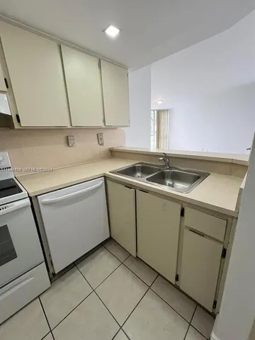 a utility room with sink dryer and washer