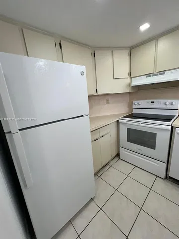 a utility room with cabinets washer and dryer