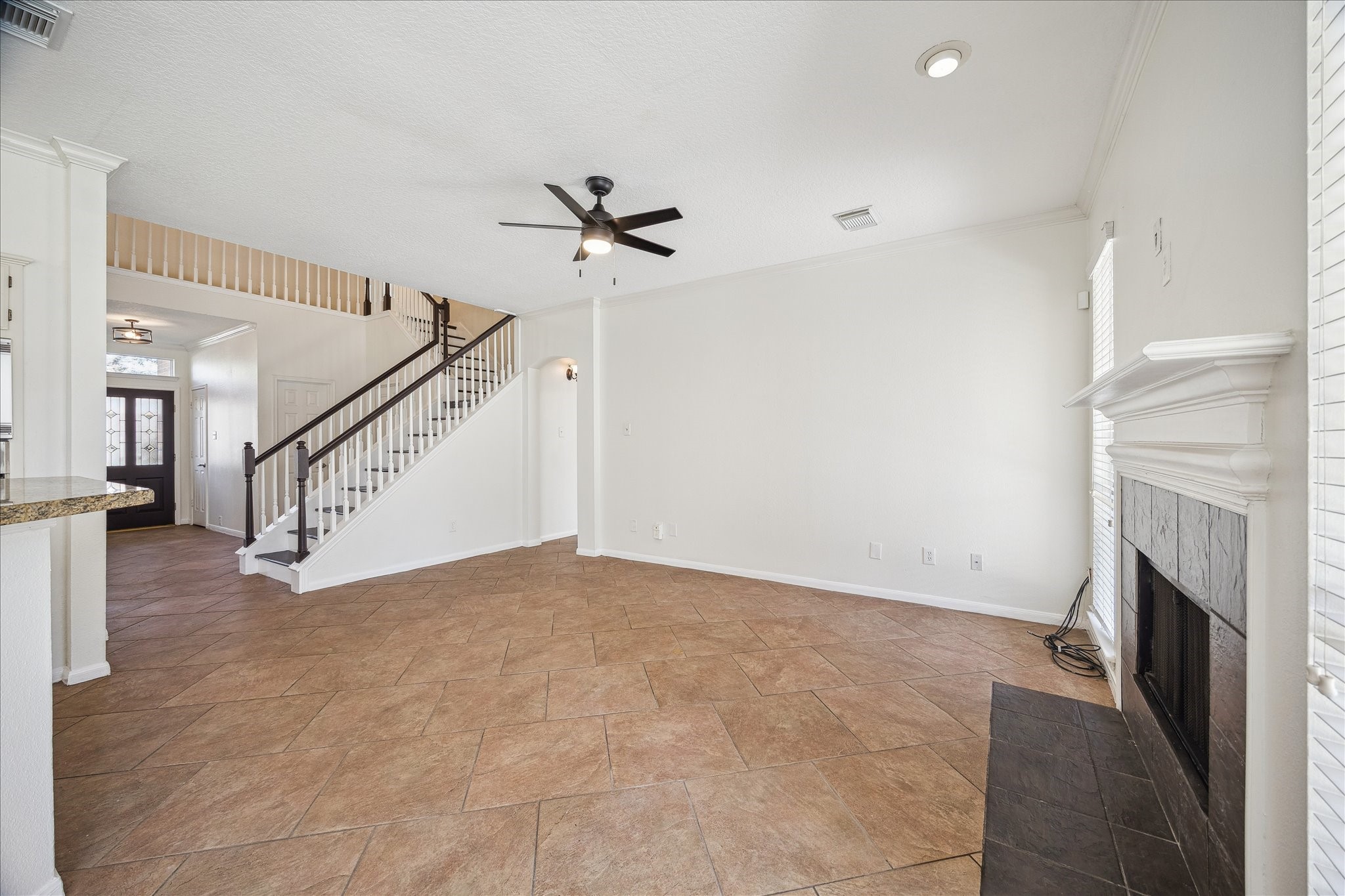 12831 Dove Point Lane Houston, TX 77041 - Photo 19 of 50 a view of empty room with wooden floor and fireplace