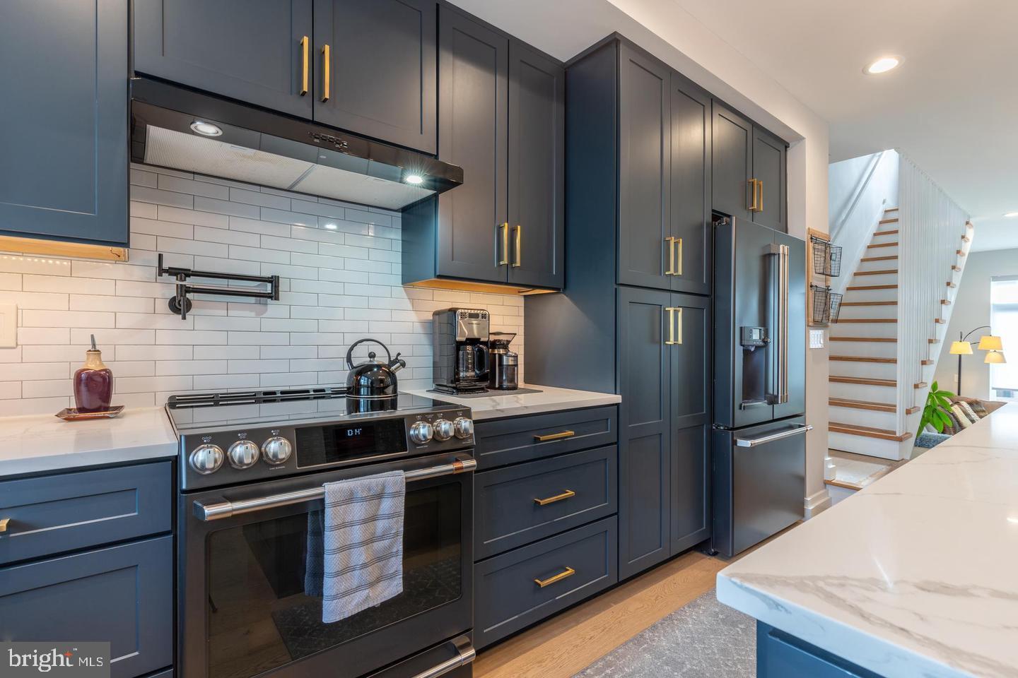 3401 Hamilton Street, Unit 13 Philadelphia, PA 19104 - Photo 25 of 33 a kitchen with stainless steel appliances granite countertop a refrigerator and a stove