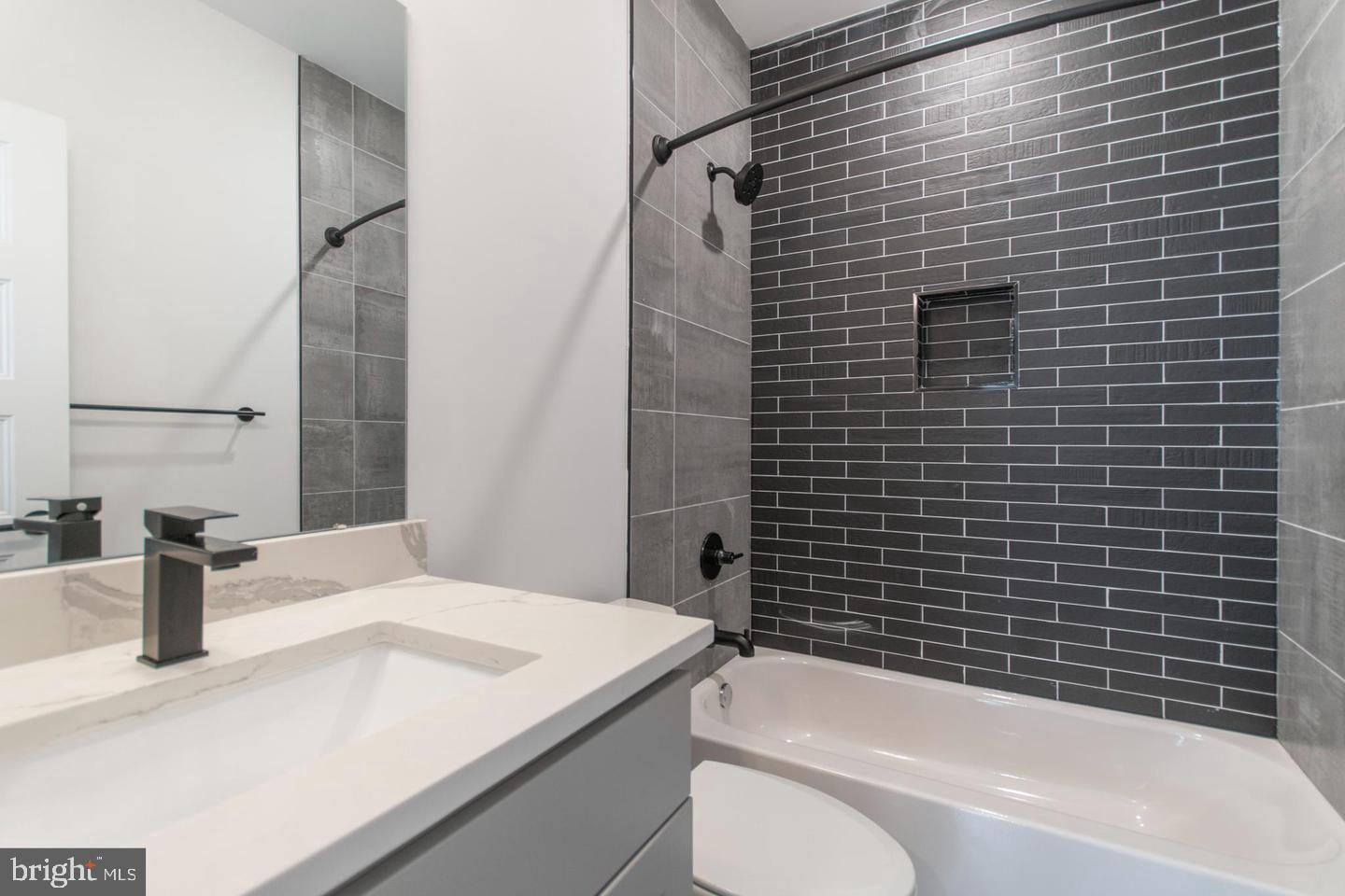 3401 Hamilton Street, Unit 13 Philadelphia, PA 19104 - Photo 29 of 33 a bathroom with a sink a toilet and shower