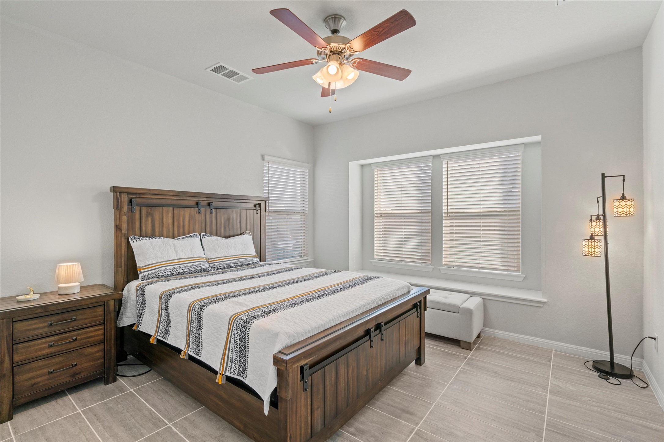 8144 Daisy Cutter Crossing Georgetown, TX 78626 - Photo 12 of 40 Bedroom featuring light tile patterned floors, baseboards, ceiling fan, and visible vents