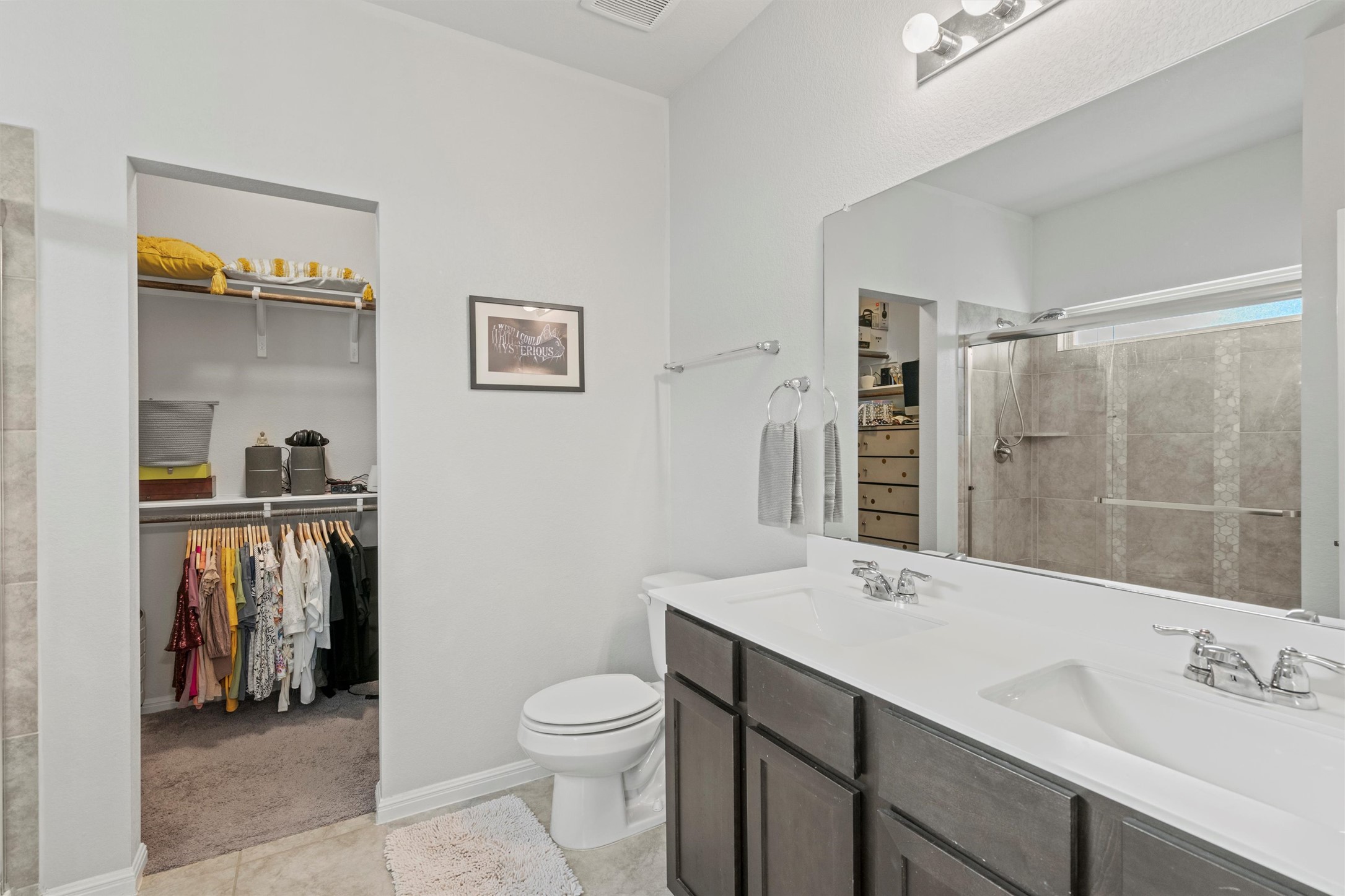 8144 Daisy Cutter Crossing Georgetown, TX 78626 - Photo 14 of 40 Full bath featuring toilet, a sink, a walk in closet, and a stall shower
