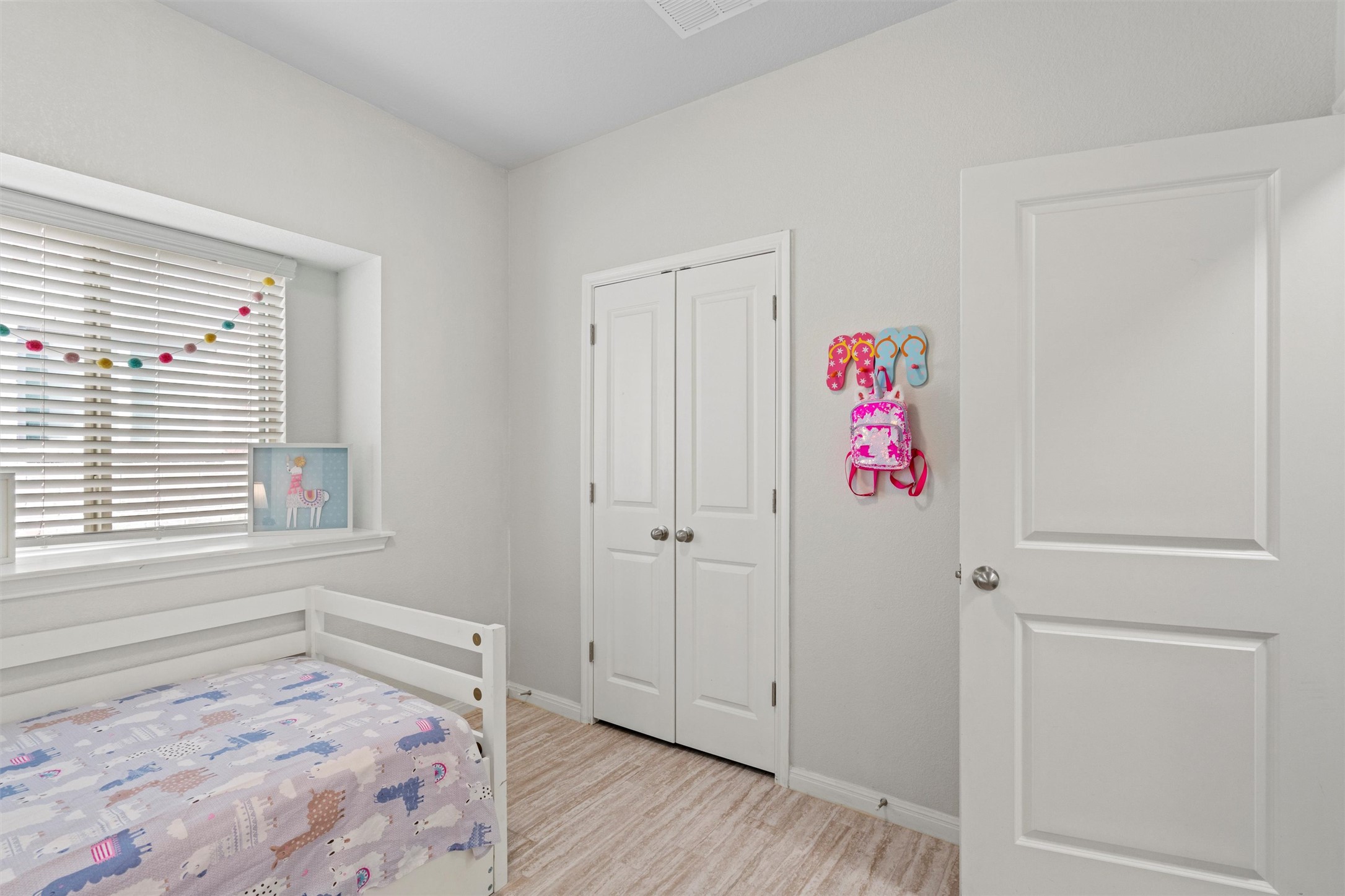 8144 Daisy Cutter Crossing Georgetown, TX 78626 - Photo 18 of 40 Bedroom with baseboards, a closet, and wood finished floors