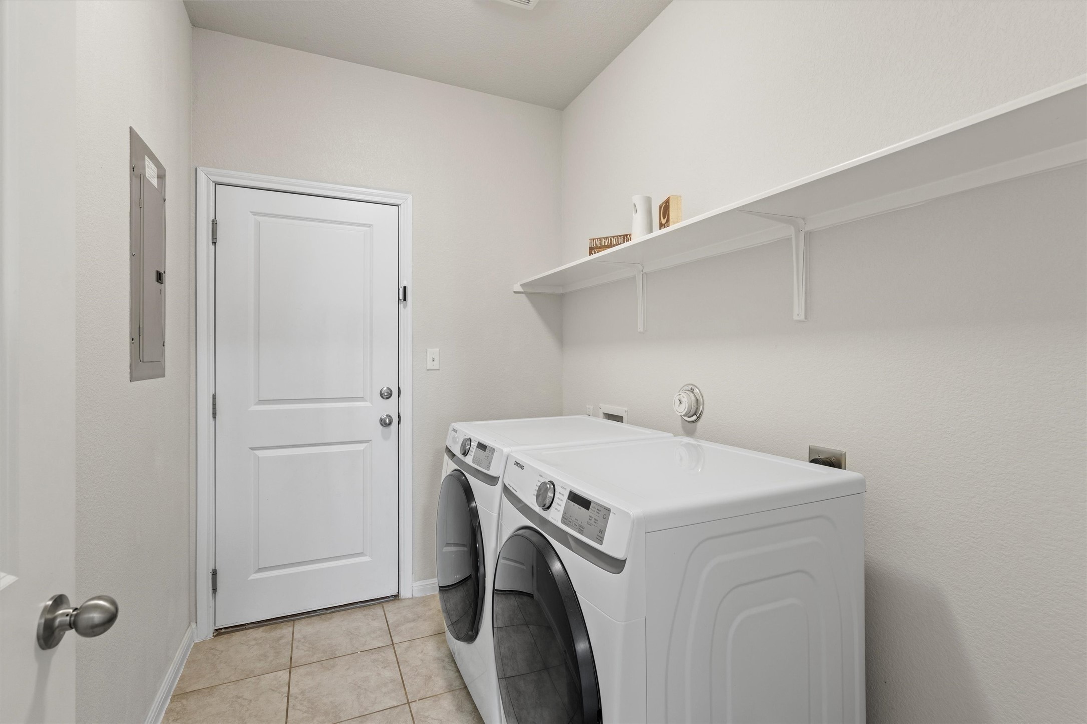 8144 Daisy Cutter Crossing Georgetown, TX 78626 - Photo 23 of 40 Laundry area featuring light tile patterned floors, baseboards, washer and dryer, laundry area, and electric panel