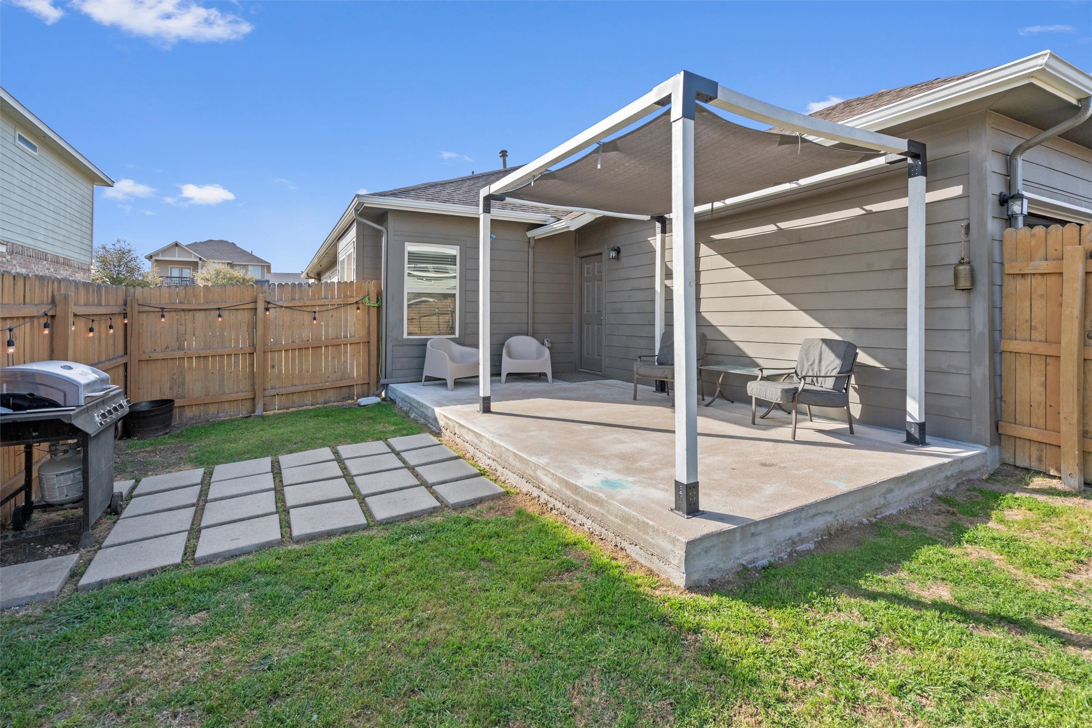 8144 Daisy Cutter Crossing Georgetown, TX 78626 - Photo 25 of 40 Rear view of property featuring a lawn, fence, and a patio