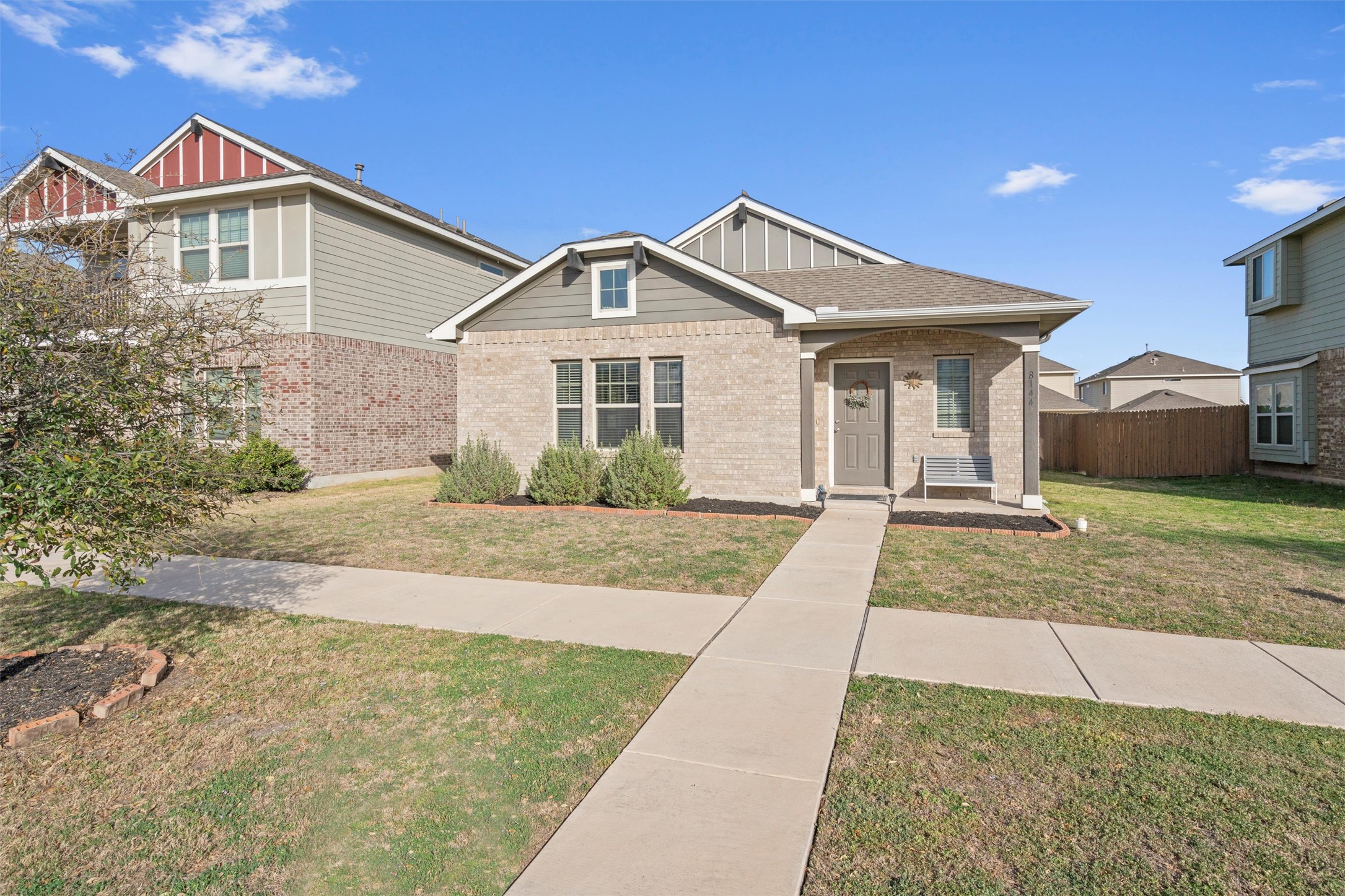 8144 Daisy Cutter Crossing Georgetown, TX 78626 - Photo 29 of 40 View of front of property featuring a front lawn, fence, and brick siding