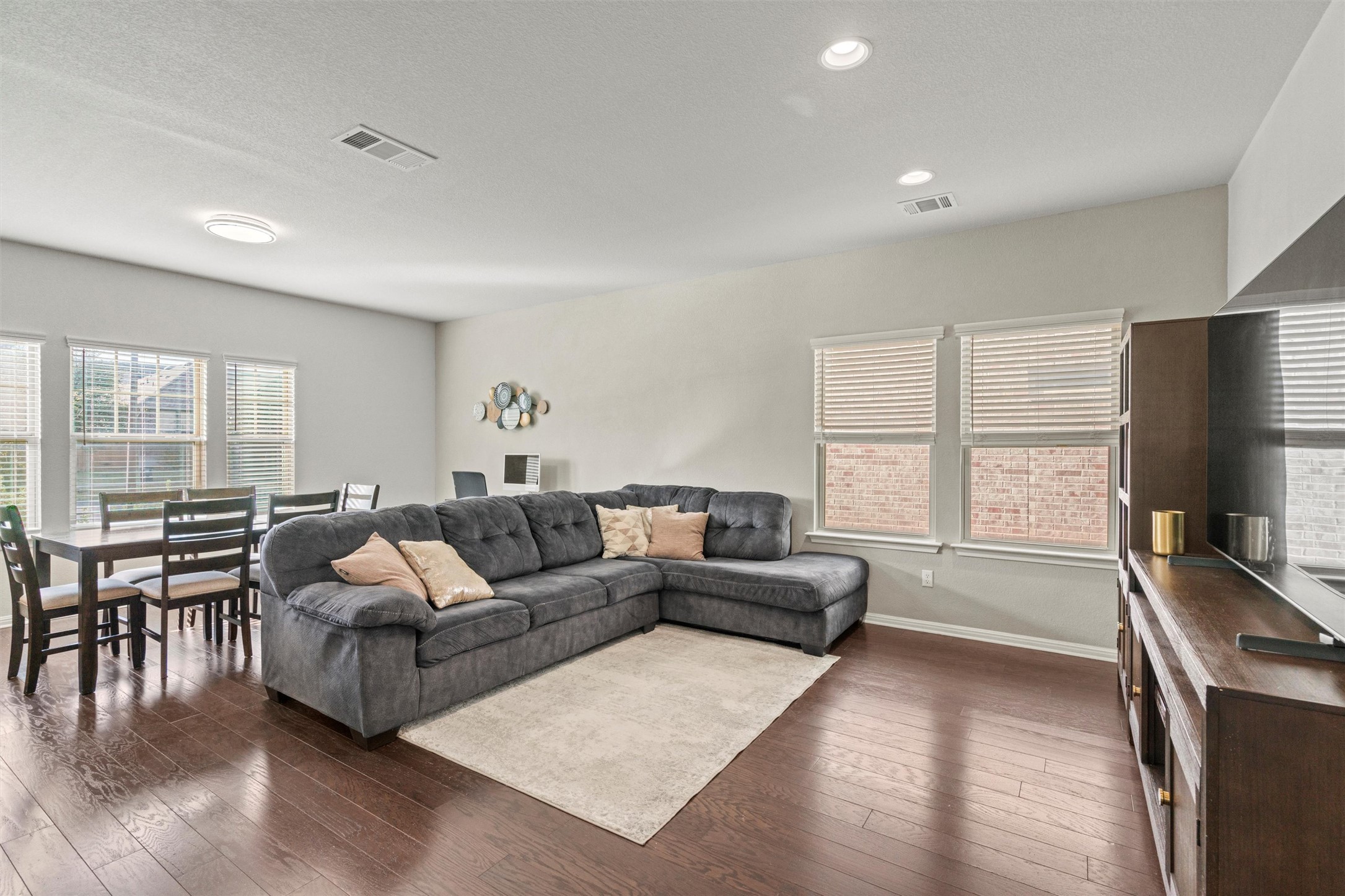 8144 Daisy Cutter Crossing Georgetown, TX 78626 - Photo 5 of 40 Living area featuring recessed lighting, dark wood-type flooring, baseboards, and visible vents