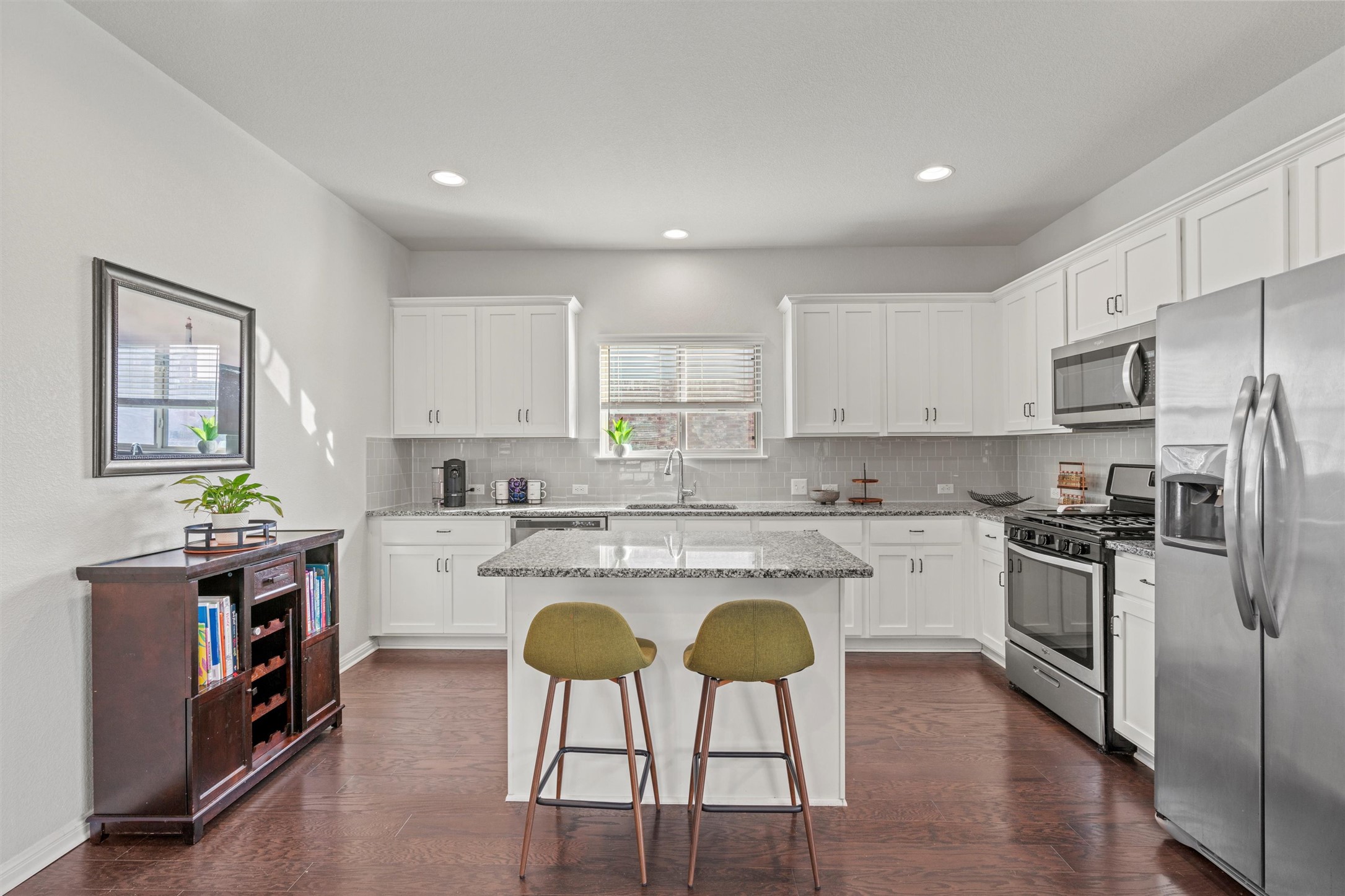 8144 Daisy Cutter Crossing Georgetown, TX 78626 - Photo 7 of 40 Kitchen featuring a sink, white cabinetry, tasteful backsplash, a center island, and stainless steel appliances