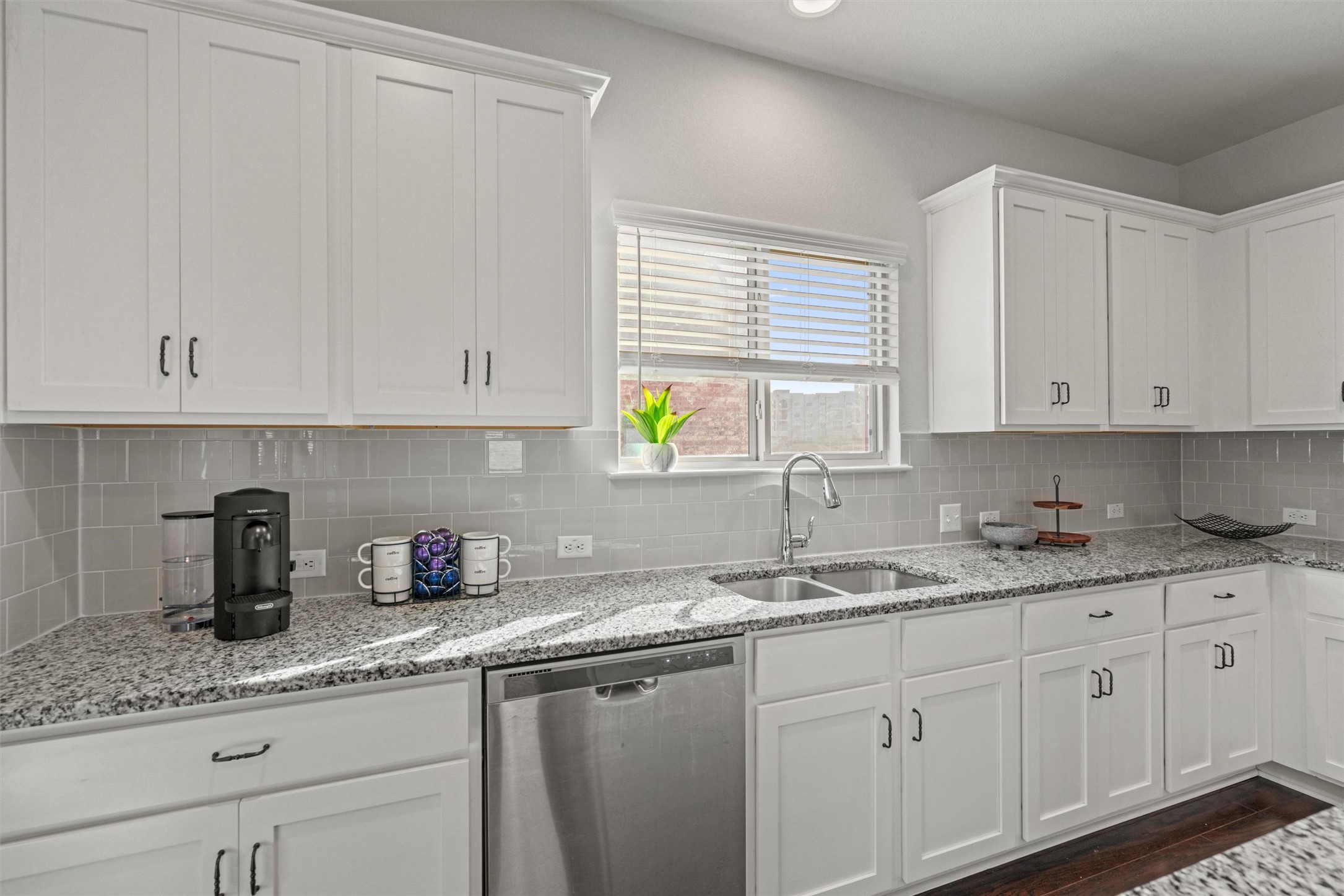 8144 Daisy Cutter Crossing Georgetown, TX 78626 - Photo 9 of 40 Kitchen featuring white cabinets, dishwasher, tasteful backsplash, dark wood-type flooring, and a sink