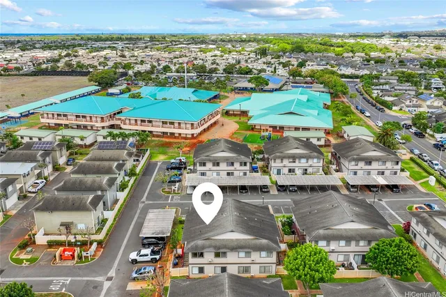an aerial view of residential houses with outdoor space