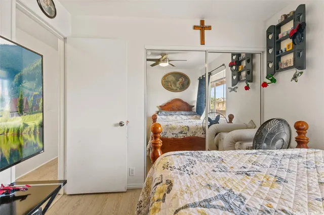 a bedroom with a bed and a mirror