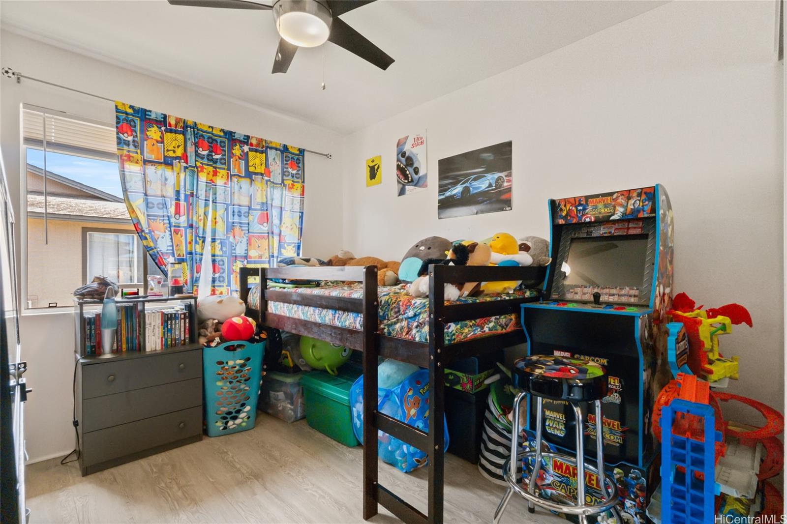91-1010 Huliau Street, Unit 5C Ewa Beach, HI 96706 - Photo 12 of 16 a living room with lots of furniture and toys