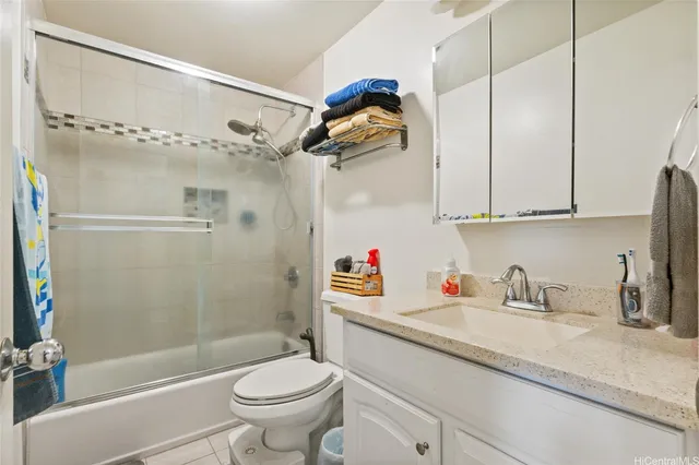 a bathroom with a sink a toilet and a shower