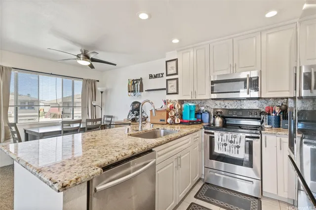 a kitchen with stainless steel appliances granite countertop a stove and a sink