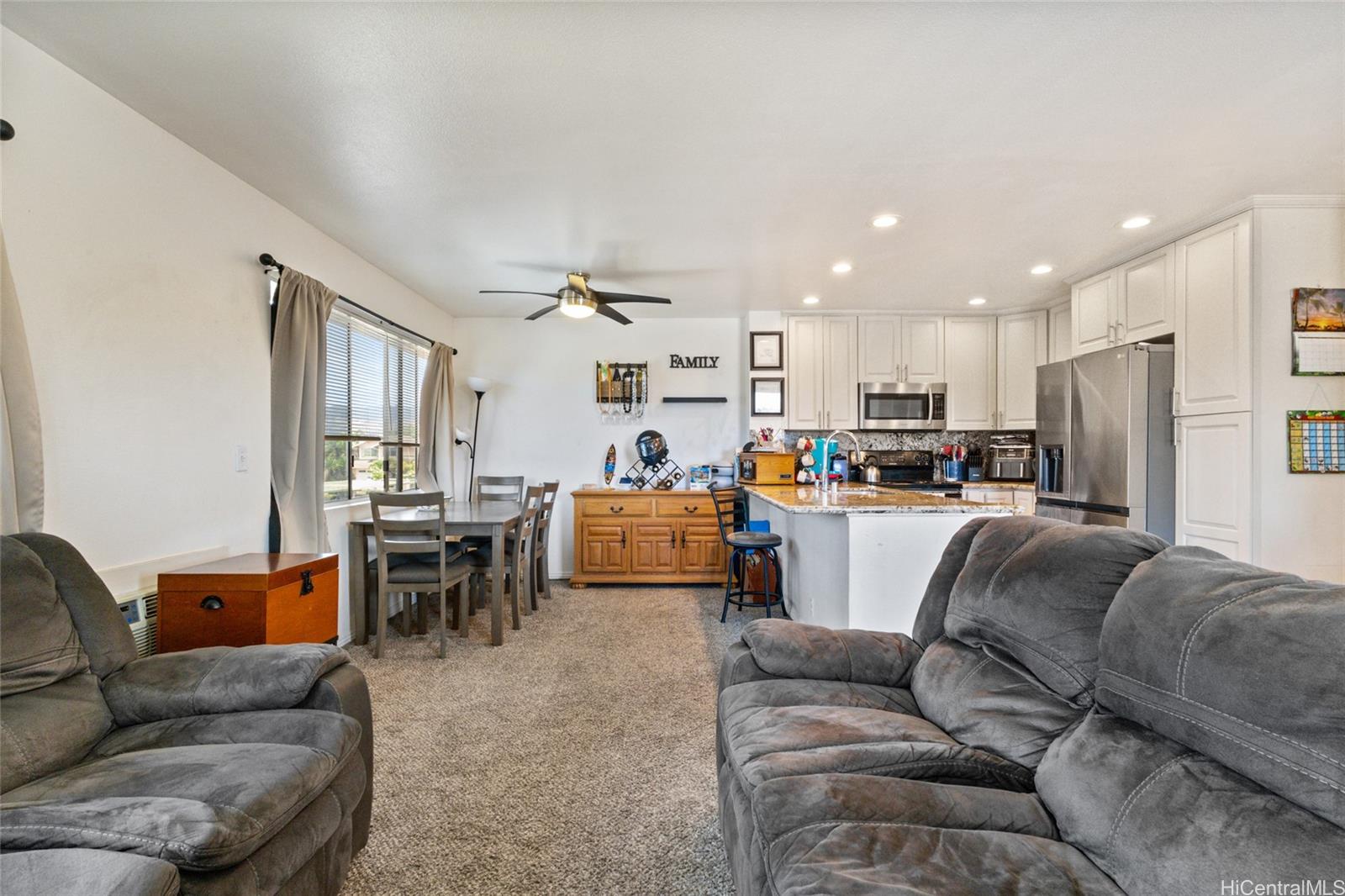 91-1010 Huliau Street, Unit 5C Ewa Beach, HI 96706 - Photo 4 of 16 a living room with furniture and kitchen view