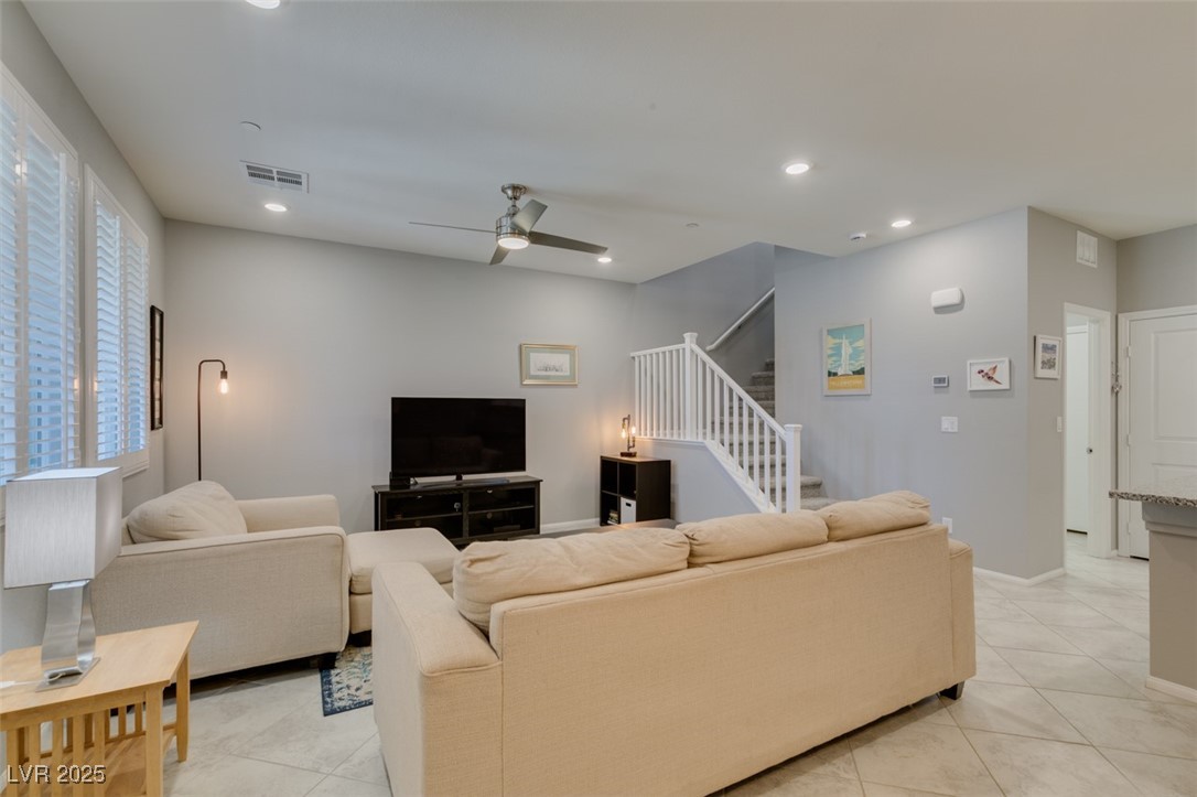 2870 Turnstone Ridge Street Henderson, NV 89044 - Photo 6 of 50 Living room featuring light tile patterned floors, stairway, a ceiling fan, recessed lighting, and baseboards