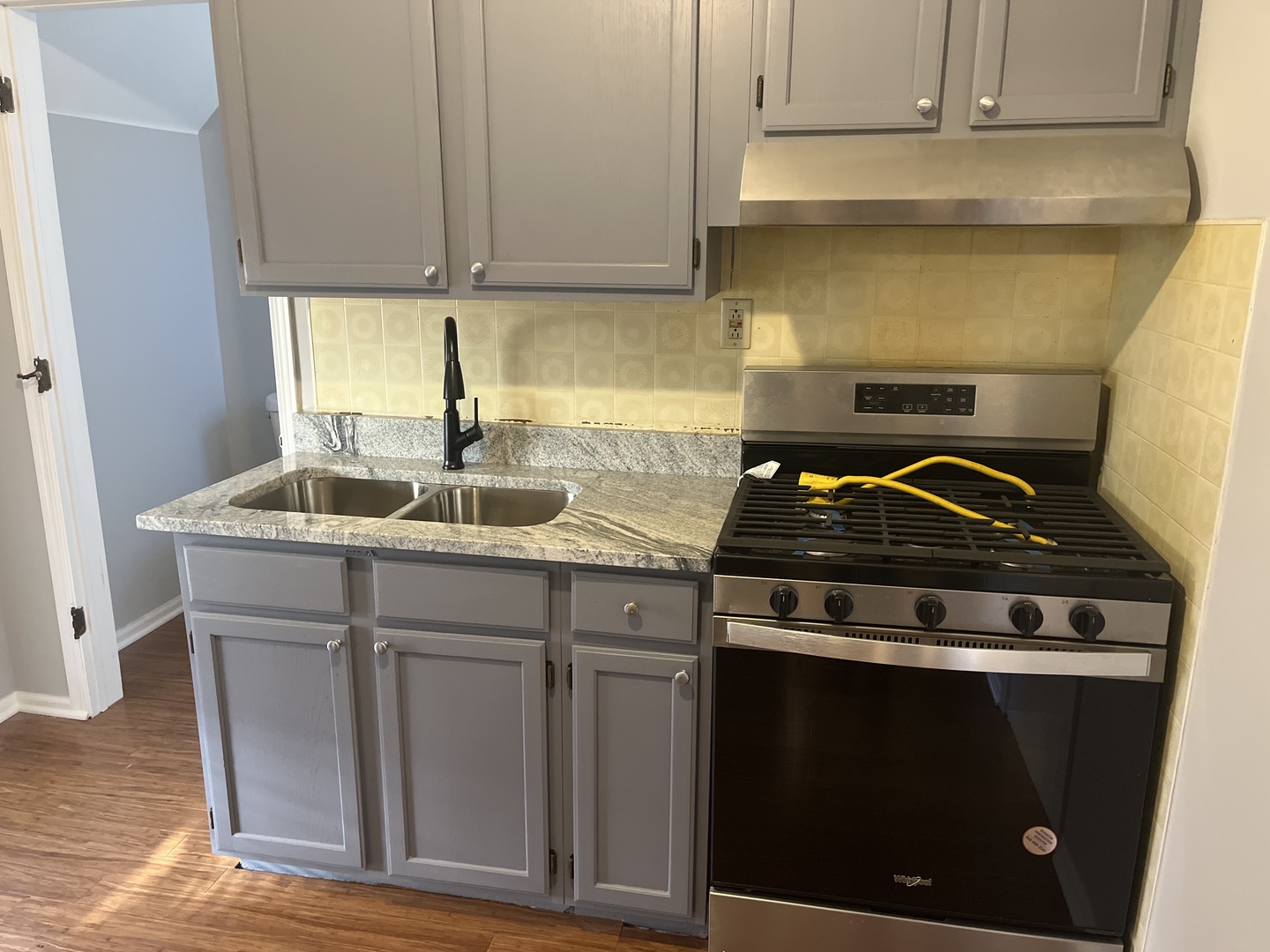 305 North View Street, Unit 2 Aurora, IL 60506 - Photo 4 of 9 a kitchen with granite countertop a stove and a sink