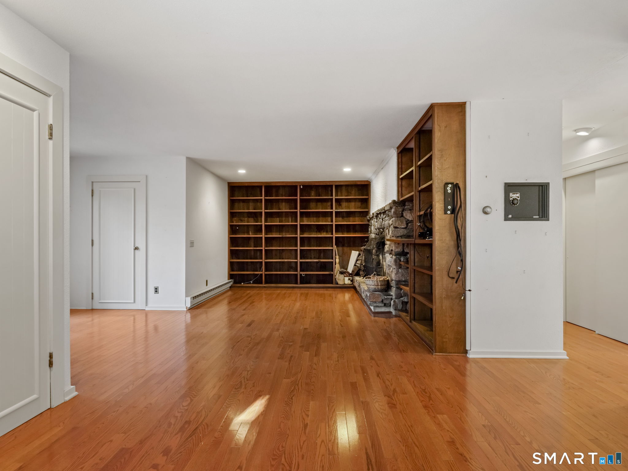 484 Cognewaugh Road Greenwich, CT 06807 - Photo 21 of 32 a view of empty room with wooden floor and windows