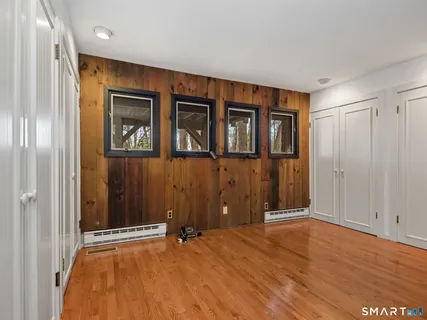 a view of an empty room with wooden floor