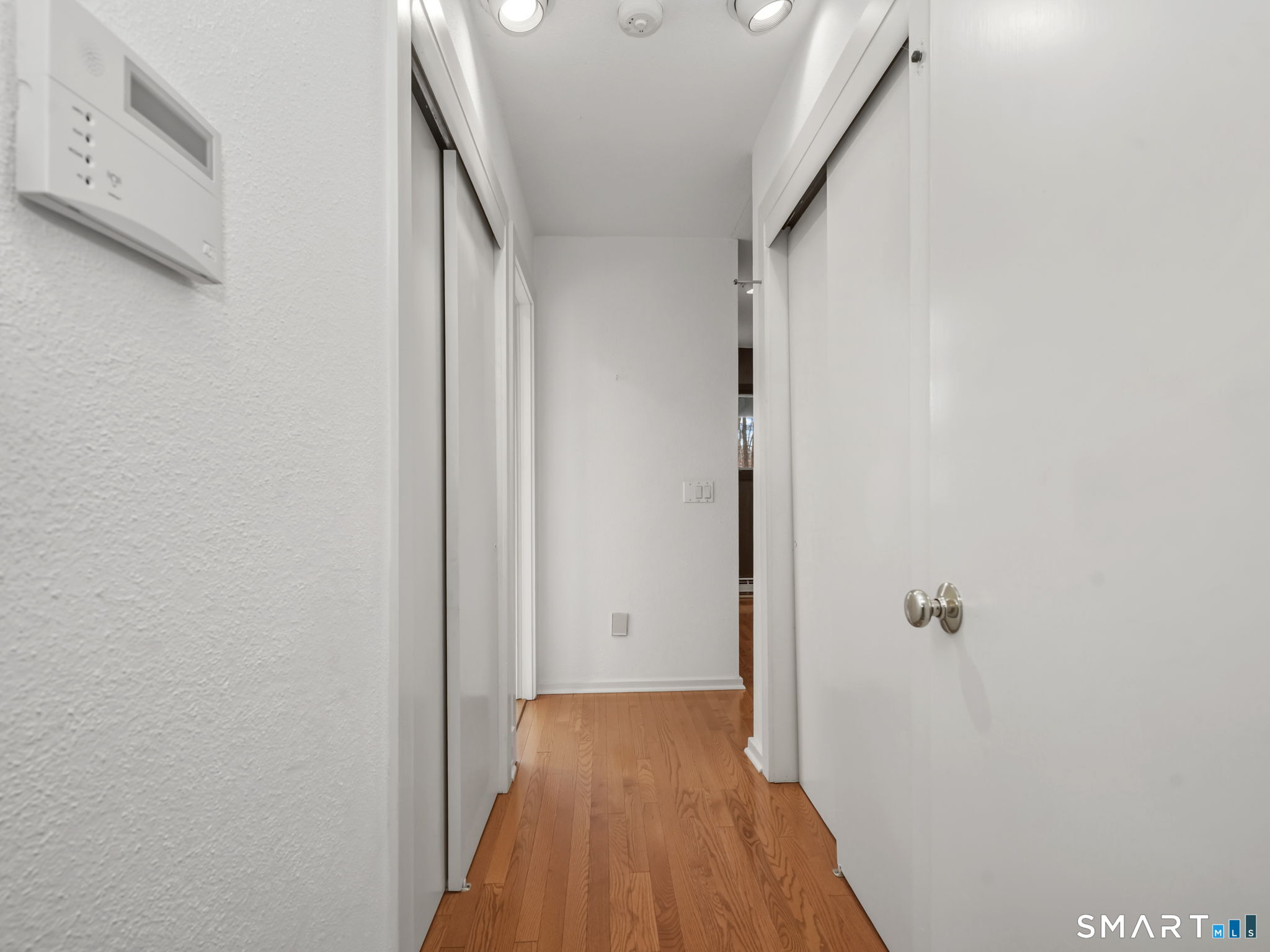484 Cognewaugh Road Greenwich, CT 06807 - Photo 23 of 32 a view of a hallway with wooden floor and closet