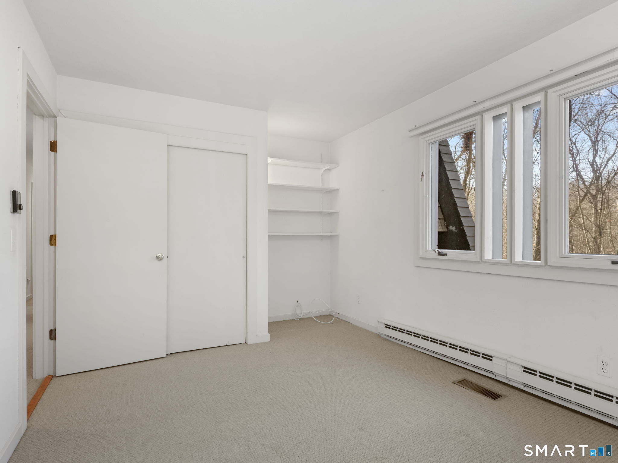 484 Cognewaugh Road Greenwich, CT 06807 - Photo 25 of 32 a view of an empty room with a window