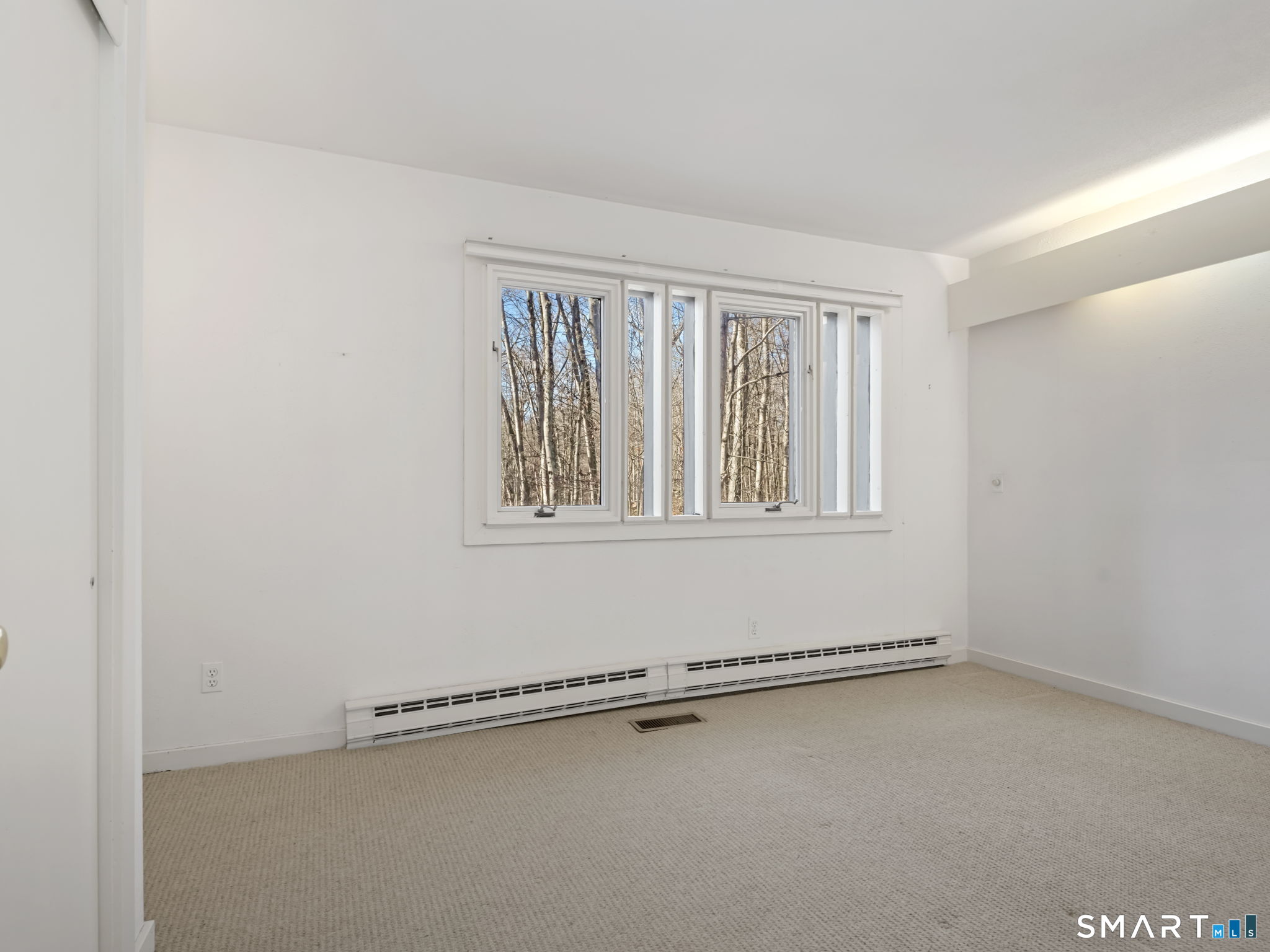 484 Cognewaugh Road Greenwich, CT 06807 - Photo 27 of 32 an empty room with a window