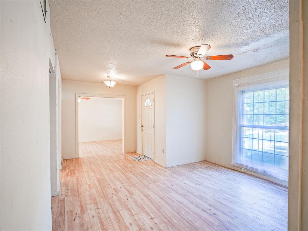 312 Germany Street Lone Star, TX 75668 - Photo 11 of 18 wooden floor in an empty room with a window