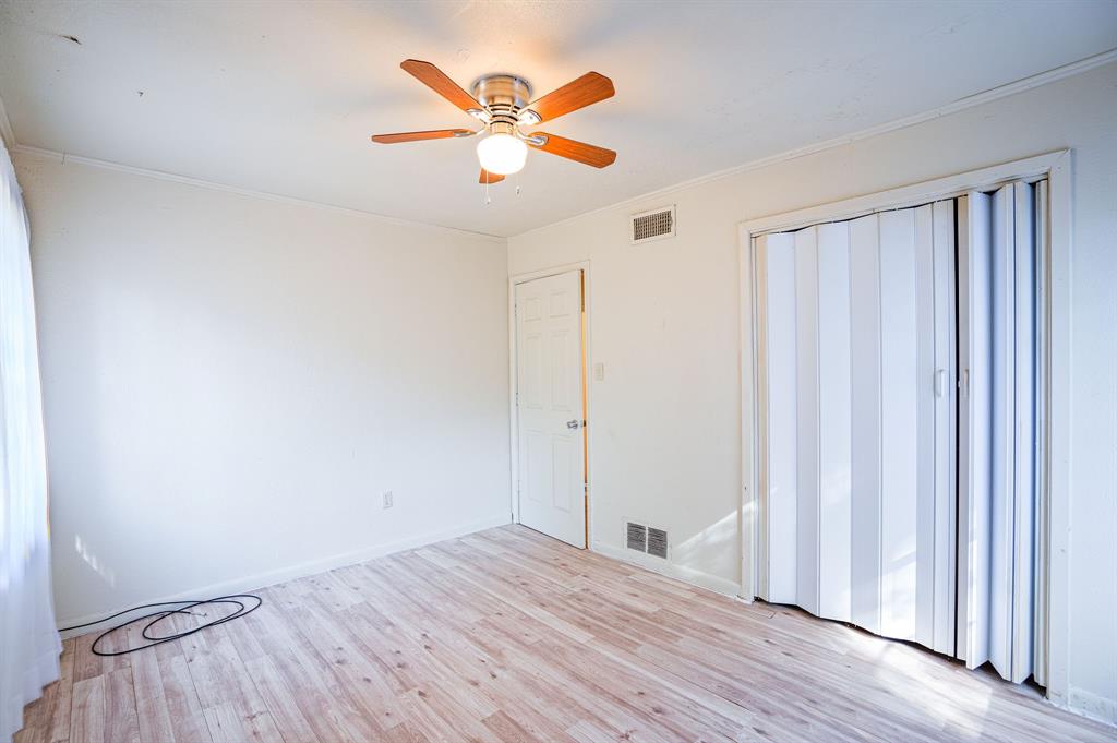 312 Germany Street Lone Star, TX 75668 - Photo 13 of 18 an empty room with wooden floor and windows
