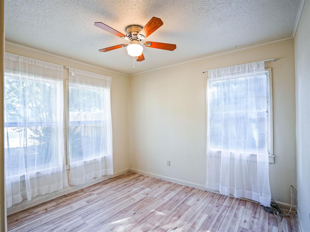 312 Germany Street Lone Star, TX 75668 - Photo 14 of 18 an empty room with wooden floor and windows