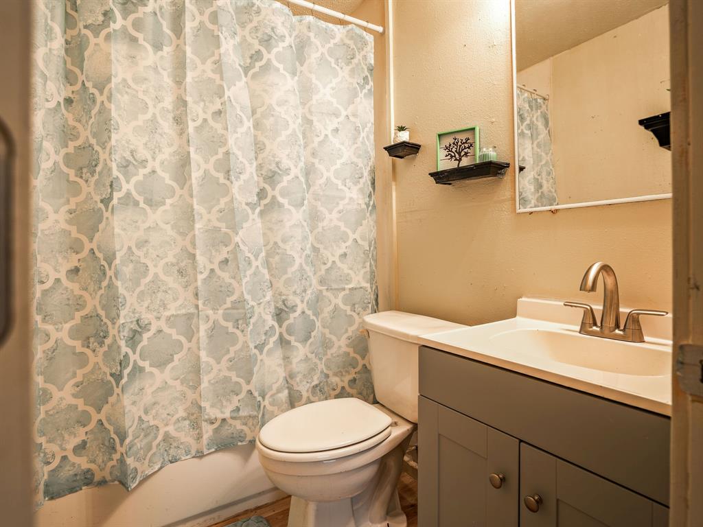 312 Germany Street Lone Star, TX 75668 - Photo 15 of 18 a bathroom with a sink and a toilet