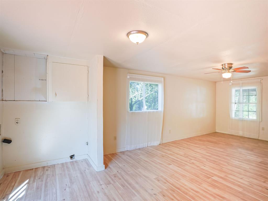 312 Germany Street Lone Star, TX 75668 - Photo 7 of 18 a view of empty room with wooden floor and fan