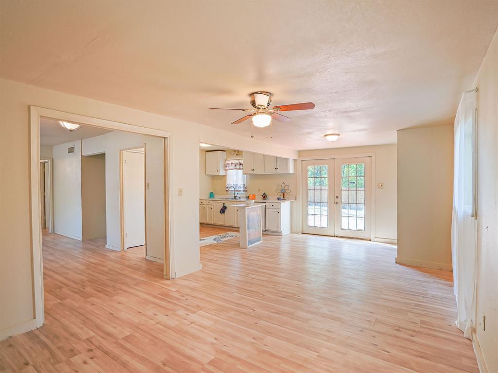 312 Germany Street Lone Star, TX 75668 - Photo 8 of 18 a view of an empty room with wooden floor and a window