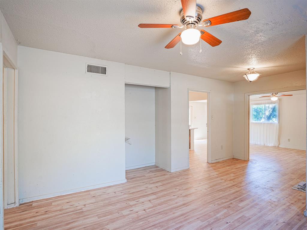 312 Germany Street Lone Star, TX 75668 - Photo 10 of 18 a view of an empty room with window and wooden floor